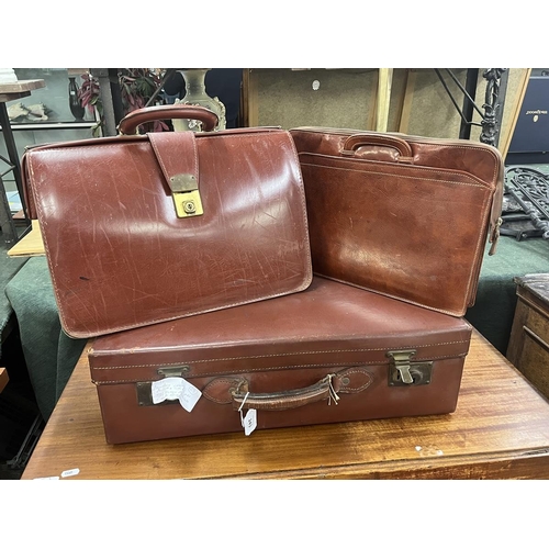 243 - Vintage leather suitcase, in as new condition, with key plus 2 1970's leather Attaché and bri... 