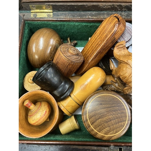 242 - Mahogany box with brass 'Bale' handle containing superb carved treen examples Inc. black forest figu... 