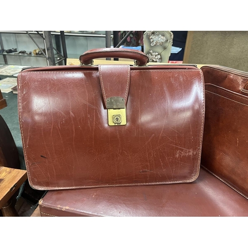 243 - Vintage leather suitcase, in as new condition, with key plus 2 1970's leather Attaché and bri... 