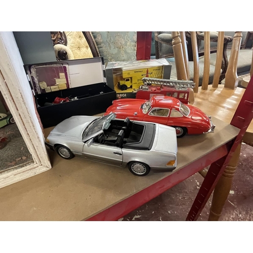 257 - Collection of model cars together with a display case