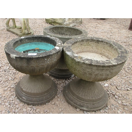 133 - 3 fluted stone Gothic style urns on round fluted socles