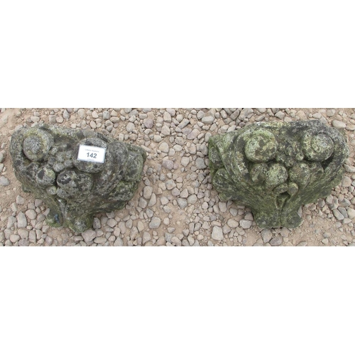 142 - Two small stone decorative wall sconces