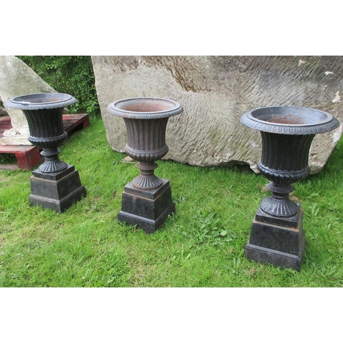 263 - A set of 3 fluted cast-iron urns on pedestals - Approx Height: 72cm  Diameter: 41cm