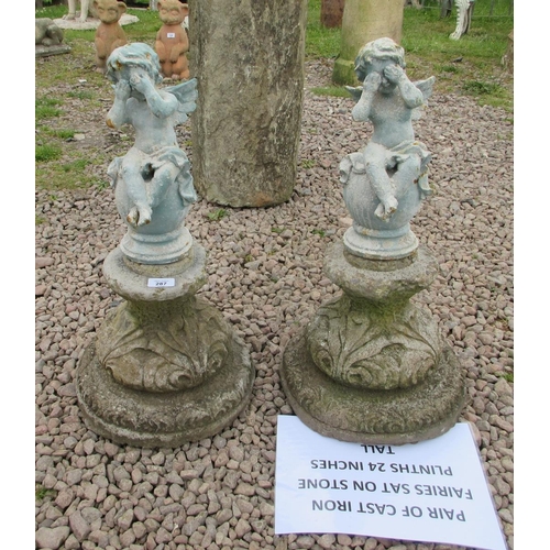 287 - Pair of cast-iron fairies sat on stone plinths