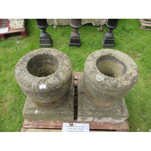 265 - Antique natural stone goblet urns on natural stone plinths