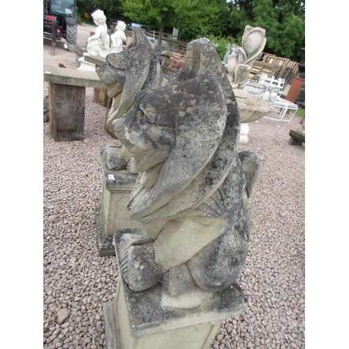 297 - Pair of stylised stone lions on stone plinths