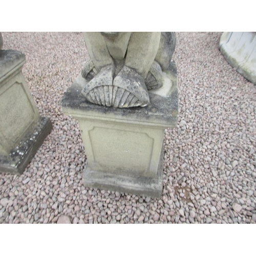 297 - Pair of stylised stone lions on stone plinths