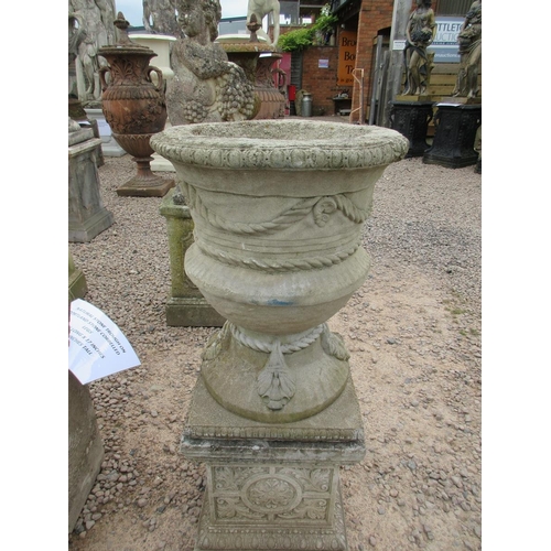 356 - Pair of reconstituted stone urns with swags and rope detail on decorative plinths - Approx Height: 1... 