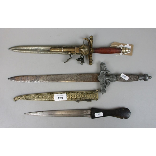 139 - French Denix made dagger/pistol replica, Toledo steel bladed dagger, and horn handled brass sheathed... 