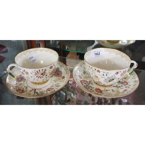 162 - Pair of hand painted Oriental cups & saucers with figured handles