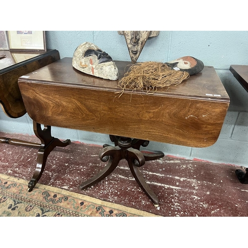 273 - Early mahogany drop leaf table with drawer on splayed support with brass castors