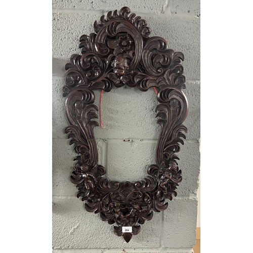 284 - Heavy carved frame adorned with cherubs 