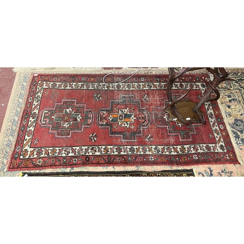 366 - Red patterned rug - Approx size 200cm x 103cm