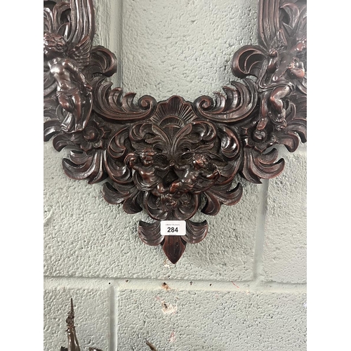 284 - Heavy carved frame adorned with cherubs 