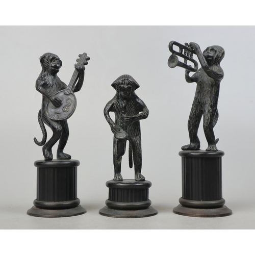 159 - Black patinated brass 3-piece band of monkey musicians standing on reeded column bases.