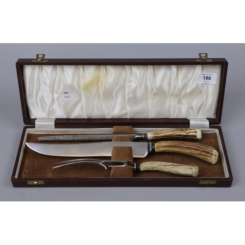 186 - Horn handled carving set in box embossed Castrol