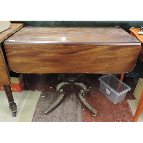 267 - Early mahogany drop leaf table with drawer on splayed support legs with brass castors