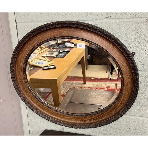 315 - Oak oval bevalled glass mirror
