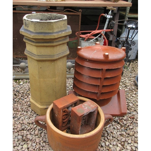 522 - 2 chimney pots together with a terracotta planter and 2 decorative air bricks