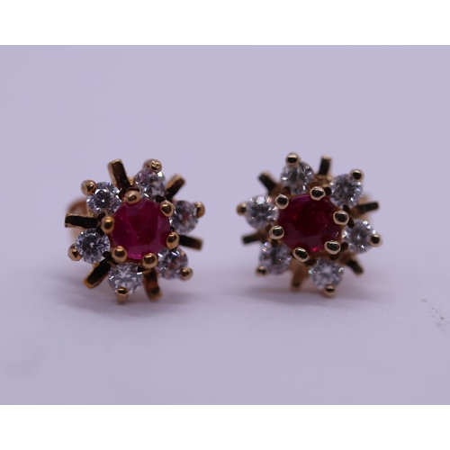 55 - Pair of red stone set gold stud earrings
