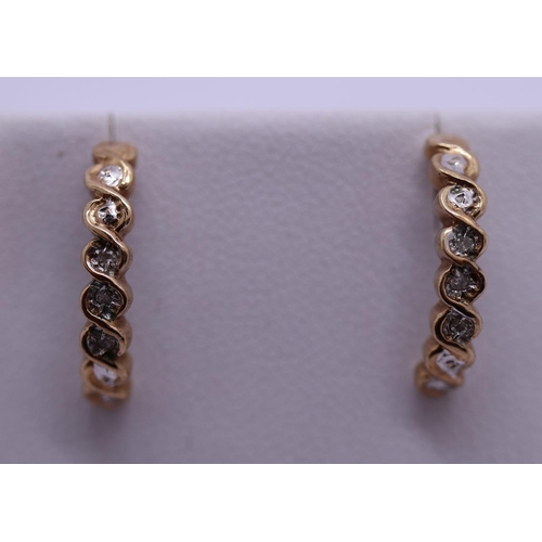 59 - Pair of 9ct gold diamond set half hoop earrings