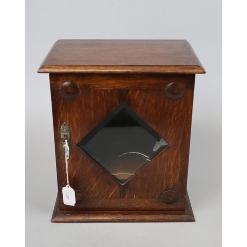 140 - Edwardian oak bevelled glazed smoker's cabinet with sprung drawer and key