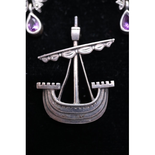70 - Pair of silver and amethyst set earrings together with a silver boat brooch