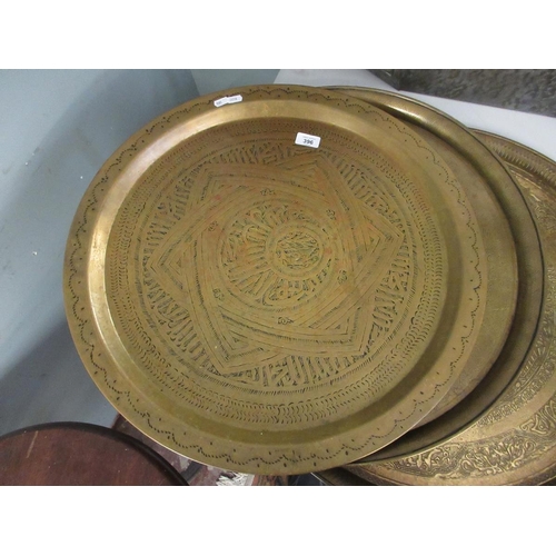 396 - 3 large engraved brass chargers. Approx 60 cm diameter.