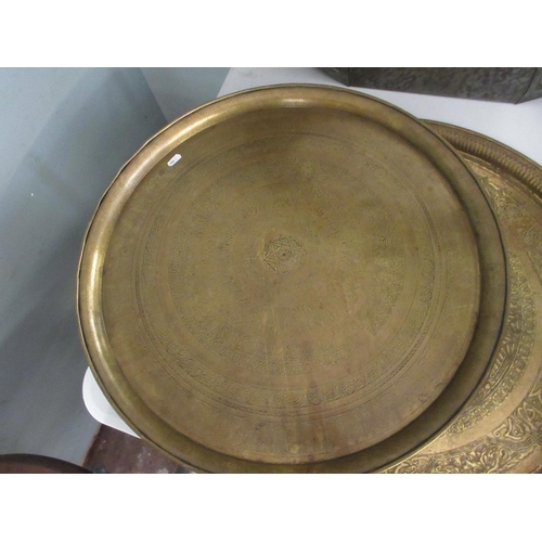 396 - 3 large engraved brass chargers. Approx 60 cm diameter.