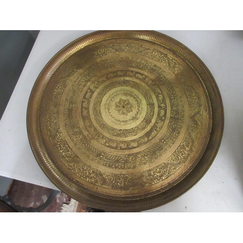 396 - 3 large engraved brass chargers. Approx 60 cm diameter.