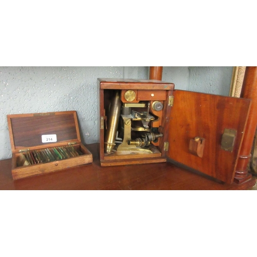 214 - Cased brass telescope with collection of slides