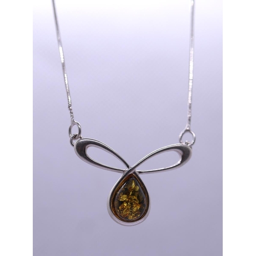 69 - Silver and amber pendant on chain