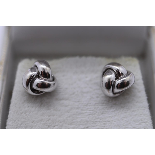 16 - Boxed pair of white gold stud earrings