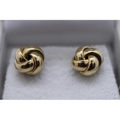 17 - Boxed pair of gold stud earrings