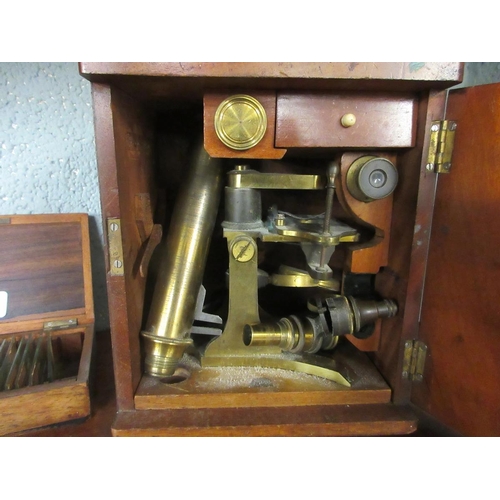 214 - Cased brass telescope with collection of slides