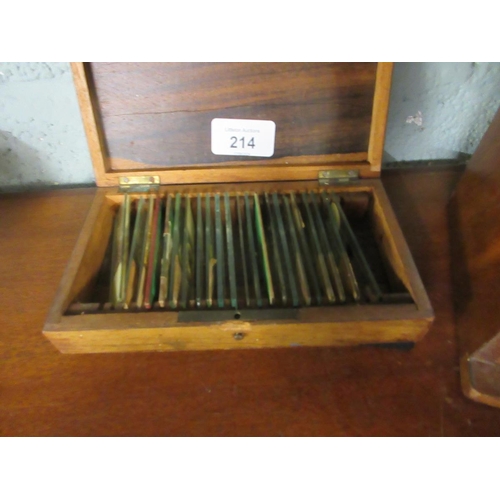 214 - Cased brass telescope with collection of slides