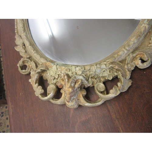 299 - Large early 19thC gilt mirror depicting a rams head at base and seated cherub - Approx Height 108cm