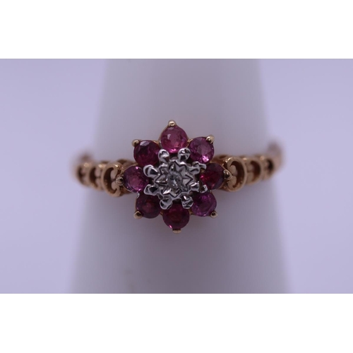 52 - 9ct gold ruby and diamond cluster ring - Size L