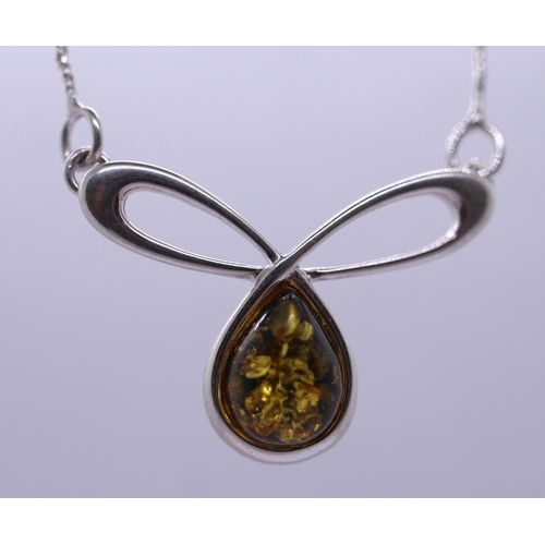 69 - Silver and amber pendant on chain