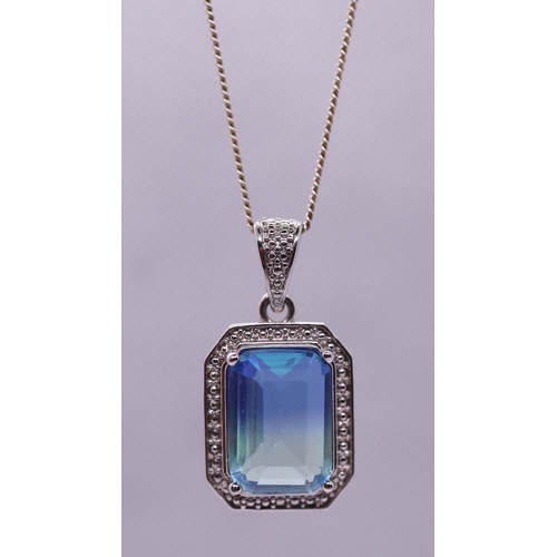 102 - Silver blue topaz set pendent on chain