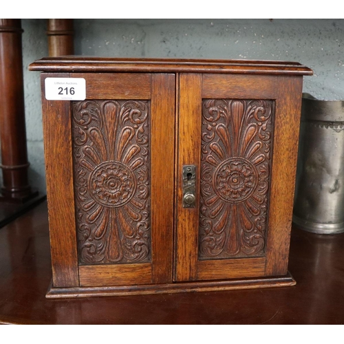 216 - Edwardian oak smokers cabinet, with collection of match books, and tobacco tins