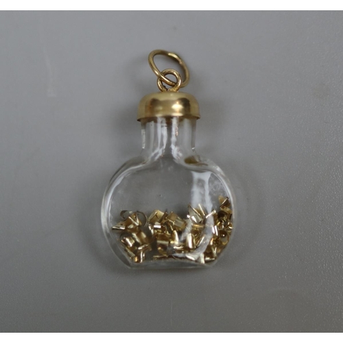 42 - 9ct gold topped bottle with gold contents