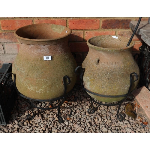 512 - Pair of stone urns on metal stands - Approx height of tallest: 55cm