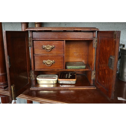 216 - Edwardian oak smokers cabinet, with collection of match books, and tobacco tins