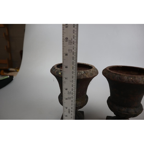 268 - Pair of small cast iron urns