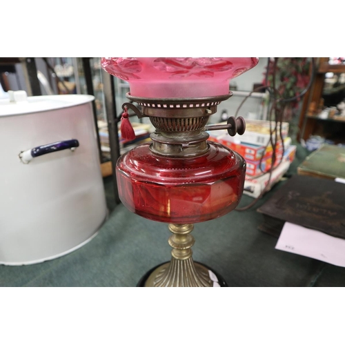 275 - Oil lamp with cranberry glass shade and reservoir