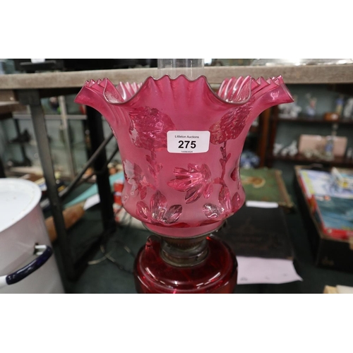 275 - Oil lamp with cranberry glass shade and reservoir