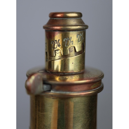 137 - A vintage copper and brass colt pistol powder flask featuring an embossed eagle together with an ant... 