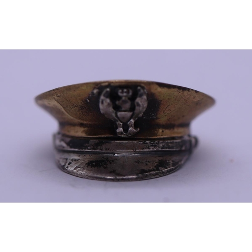 63 - Small white metal and brass military cap