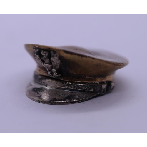 63 - Small white metal and brass military cap